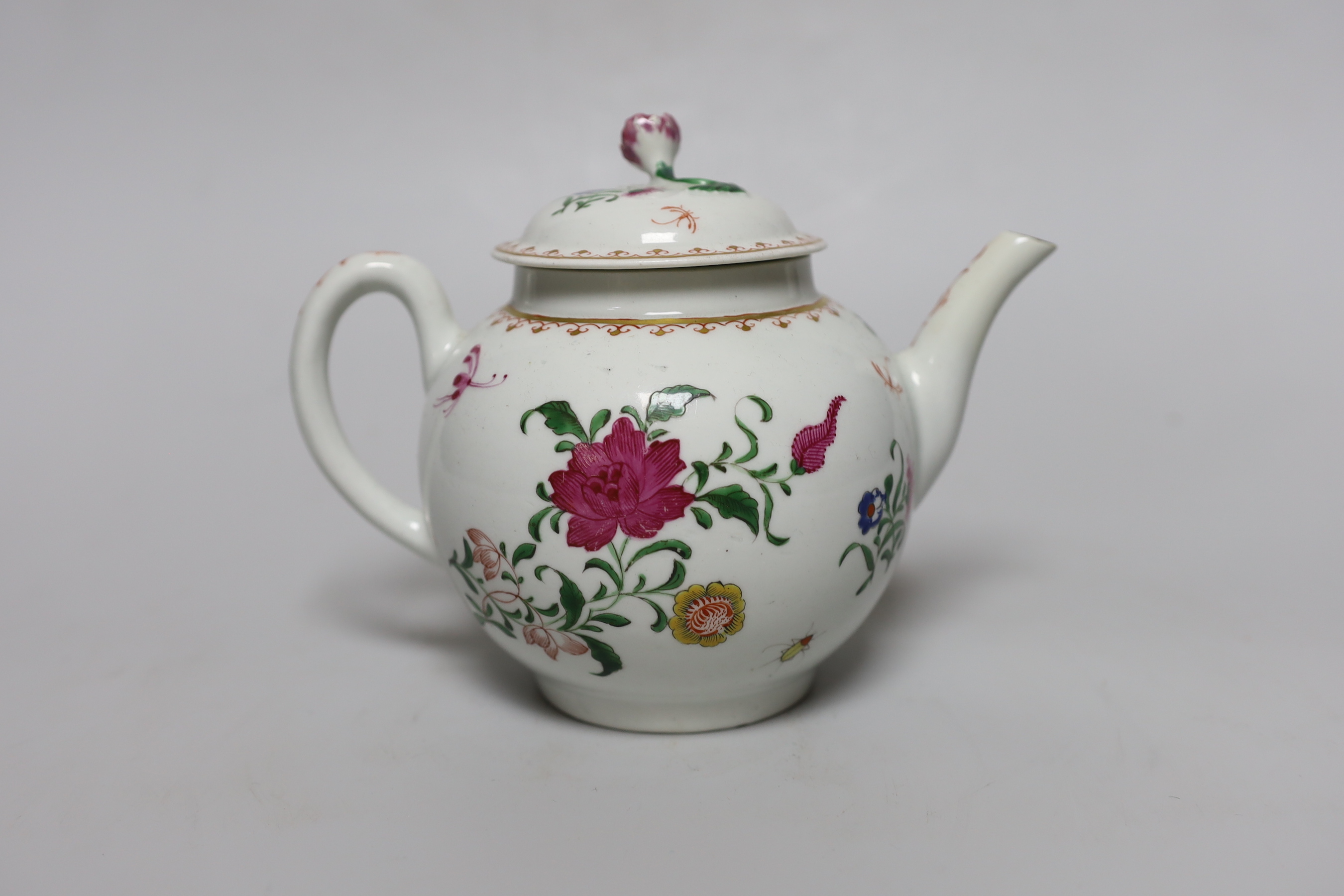 A Worcester teapot and cover, painted with Chinese style flowers and winged insects, c.1770, 14cm tall